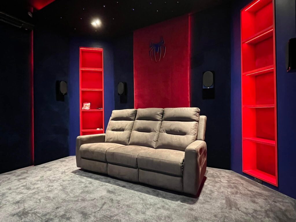 Main seating position showing surround speaker placement inside Spider-Man Home Theater.