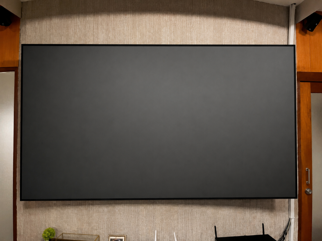 Genius Screen Optical 8K 100-inch projection screen installed for a premium home theater by HDT Homedigital.