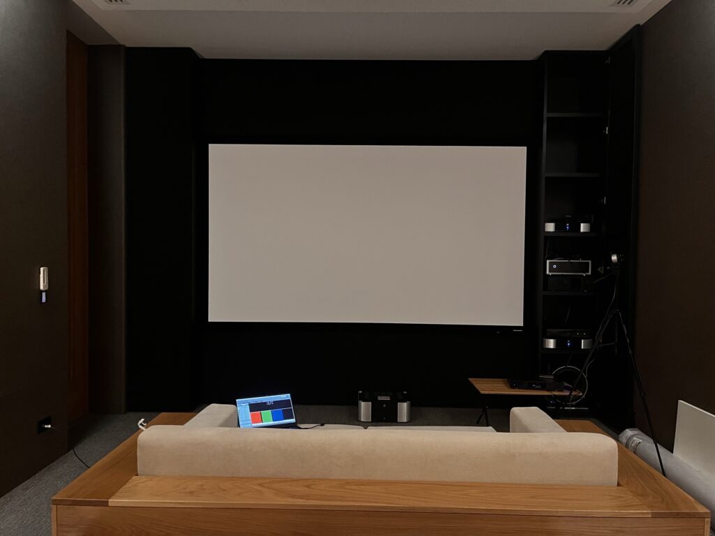 Home Theater with Epson EH-LS12000 projector and Genius Screen Acoustic Transparent 8K 150-inch screen during Video Calibration by HDT Homedigital.